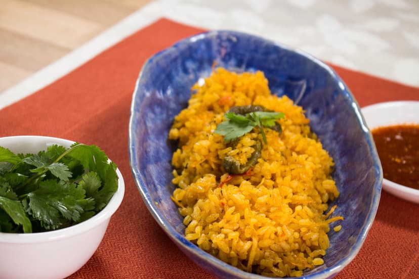 Mexican rice styled with cilantro and salsa on a warm placemat
